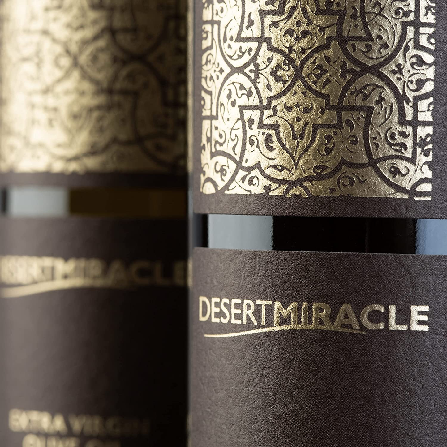 Close-up of Desert Miracle bottle label gold pattern.