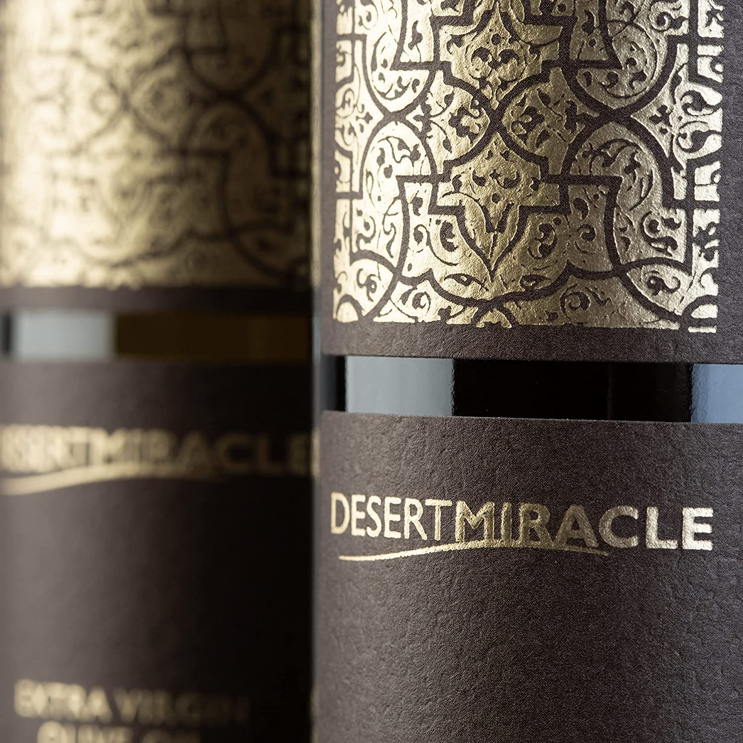 Close-up of Desert Miracle bottle label gold pattern.