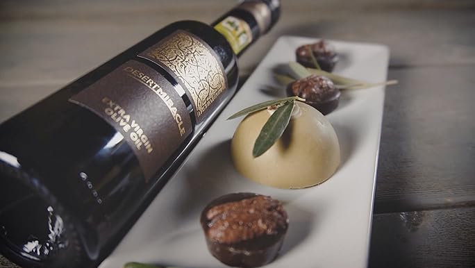 Desert Miracle EVOO bottle with mezze plate and dates.